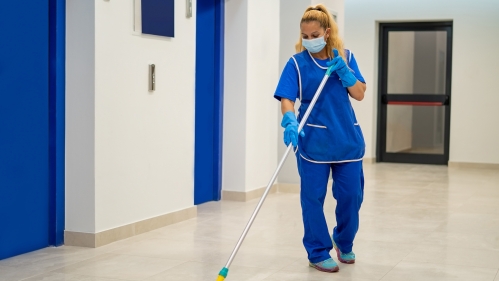 A custodial worker sweeps a floor