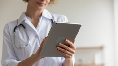 A doctor uses a tablet