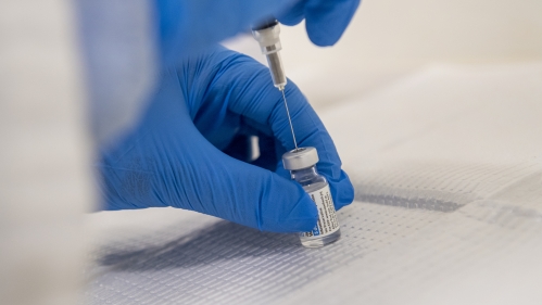 A researcher draws a vaccine
