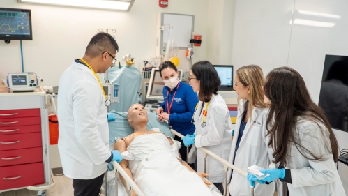 Pharmacy students practice on a mannequin in a skills lab
