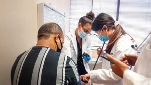 Medical students examine a patient in a clinic in Newark