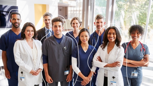 A group of healthcare workers stands in a hospital