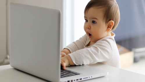 baby looks at laptop