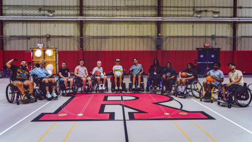 Members of True Grit camp, all of whom are in wheelchairs, gather after a basketball game (2025)
