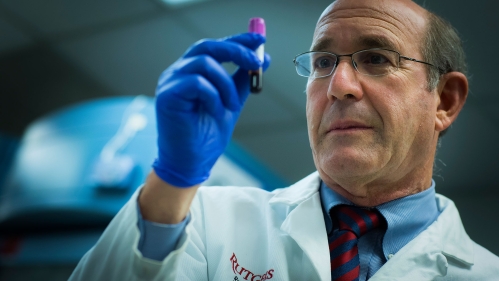 Jeffrey Carson examines blood vial