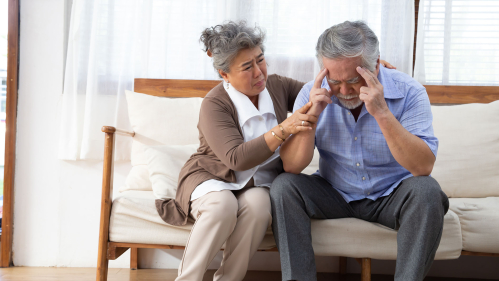 elderly Asian couple on sofa