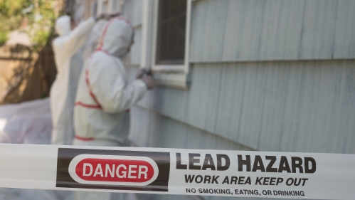 workers in haz-mat suits remove lead paint
