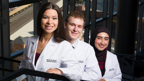 From Left to right: Geana Marte, Jacob Labovitz and Myera Mian wearing their white coats