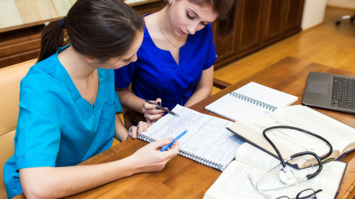 nursing student studies with professor