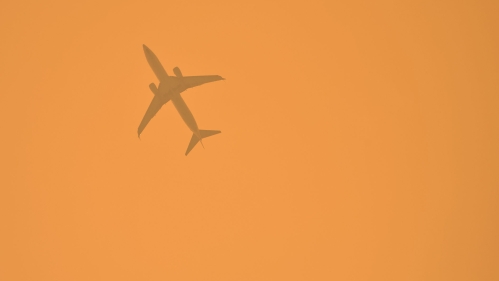 jet seen through wildfire smoke