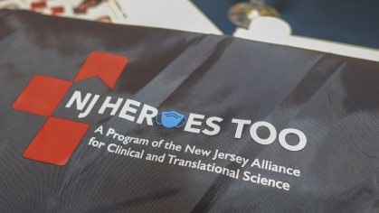 A bag with the NJHEROESTOO logo at a conference