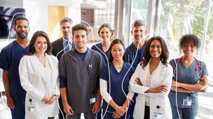 A group of healthcare workers stands in a hospital