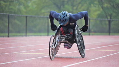 Man in wheelchair racing on a track