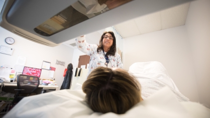 A technician scans a patient