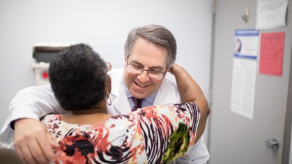 A physician hugs a patient