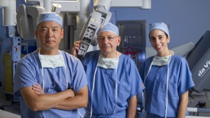 Three NJMS surgeons stand in an operating room