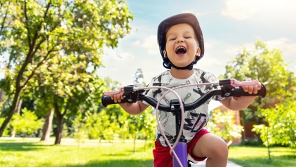 Child Riding Bike Through Neighborhood
