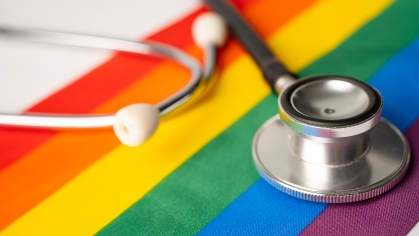 Black stethoscope on rainbow background, symbol of pride and LGBTQ+ health