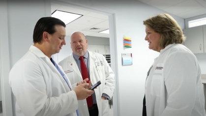 NJMS transplant team physicians talk outside of an exam room at University Hospital