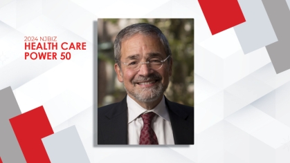 Portrait of Chancellor Brian Strom on a white and red and gray background for the 2024 NJBIZ Health Care Power 50 list