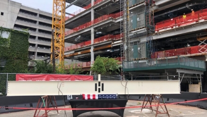 The final steal beam sits in front of the Helix construction site in New Brunswick ready to be put in place.