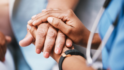 Doctor holding patient hand