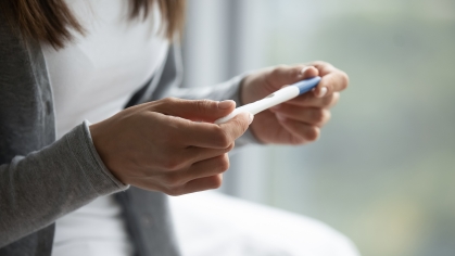 Women holding pregnancy test