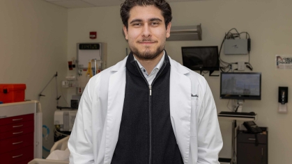 Omar M. Abuattieh stands in a lab room in the Ernest Mario School of Pharmacy.