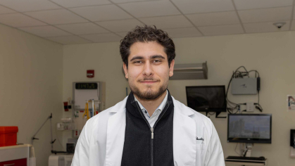 Omar M. Abuattieh stands in a lab room in the Ernest Mario School of Pharmacy.