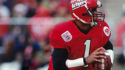 Ray Lucas is shown in his Rutgers gear on the field holding a football