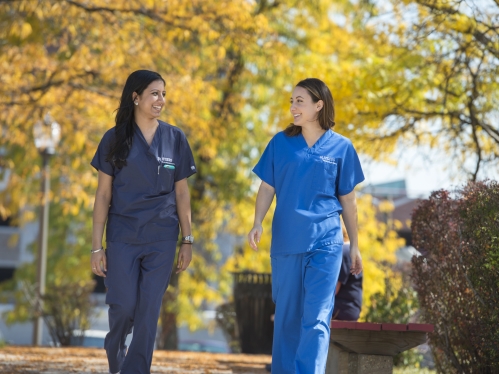 Dental students walk outside in Newark