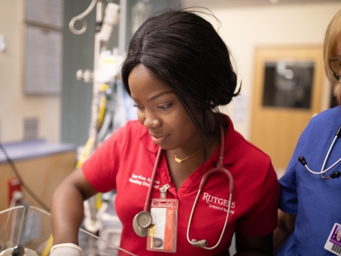 A nursing student cares for a newborn