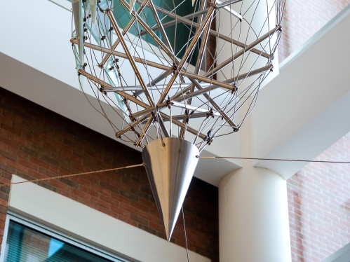 A sculpture hangs in the School of Public Health