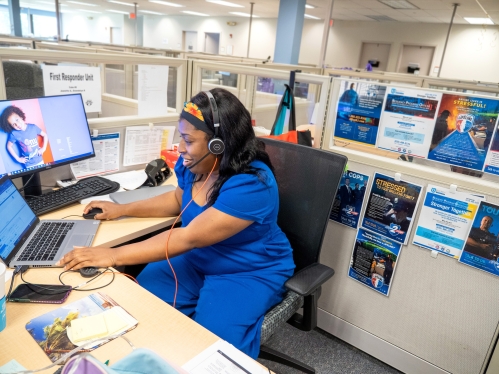 A University Behavioral Health Care employee answers phones in the call center 