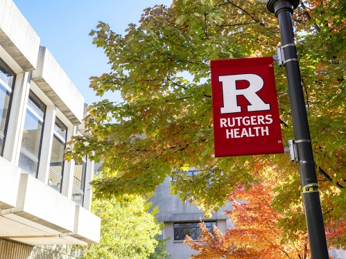 A scarlet banner bearing the Rutgers Health logo