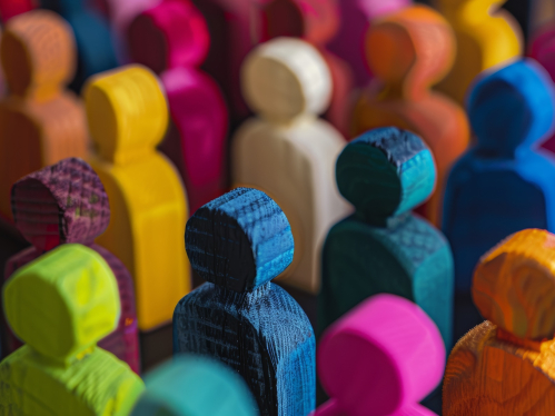 Multicolored wooden stick figurines depicting people