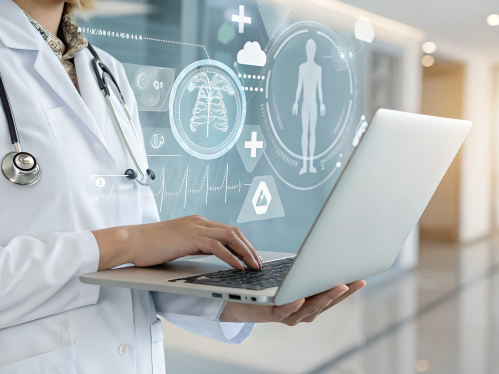 A doctor works on a laptop