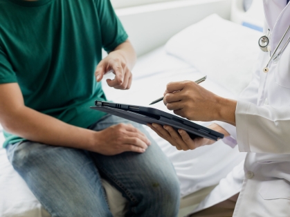 doctor screens sitting patient