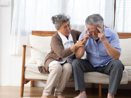 elderly Asian couple on sofa
