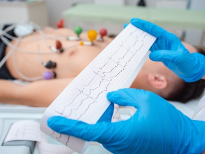 hands holding ECG readout