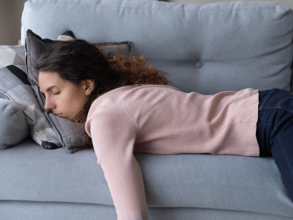 woman sleeps on sofa