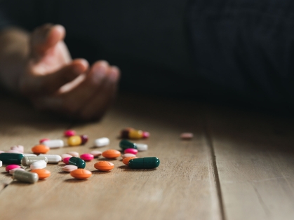 Pills near an empty hand after suicide