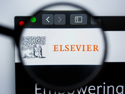 Magnifying glass over Elsevier website 