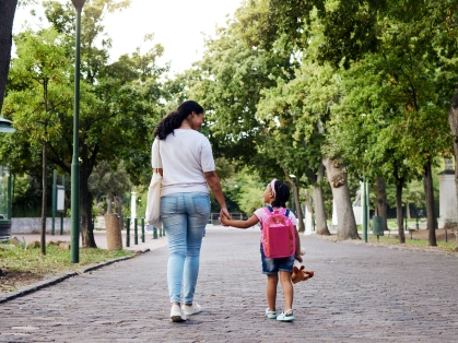 mother walks in park with daughter