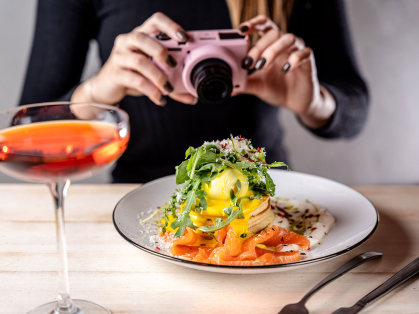influencer photographs food and cocktail