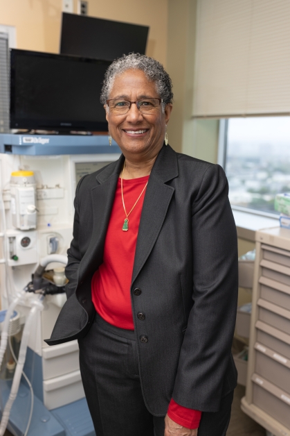 Denise Rodgers stands in a medical exam room