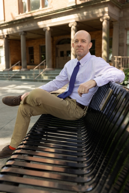Dave Weinstein sits on a bench at Rutgers