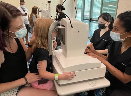Student Sight Savers at Rutgers New Jersey Medical School use a machine to examine a child's eyes