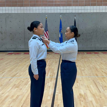 Bea Mikayla Faigal (left) is awarded the Silver Valor Award from Lt. Col. Kristine E. Poblete in the gymnasium of the Sonny Werblin Recreation Center at Rutgers.