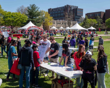 People stop by the Rutgers University Supply Chain Association (RUSCA) table during Rutgers Day 2022 on Busch campus.